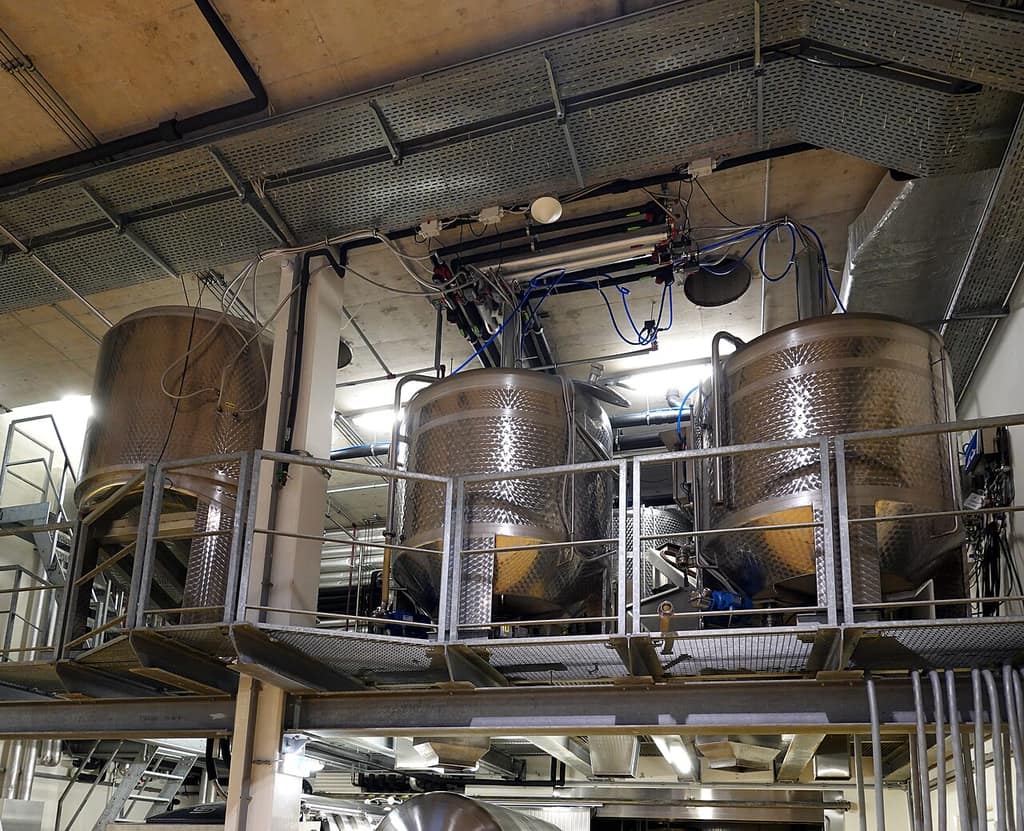 Stainless steel storage tanks on a raised platform